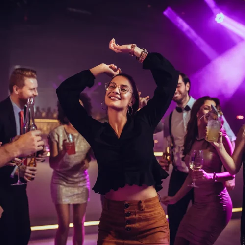 People dancing and socializing at a club party.