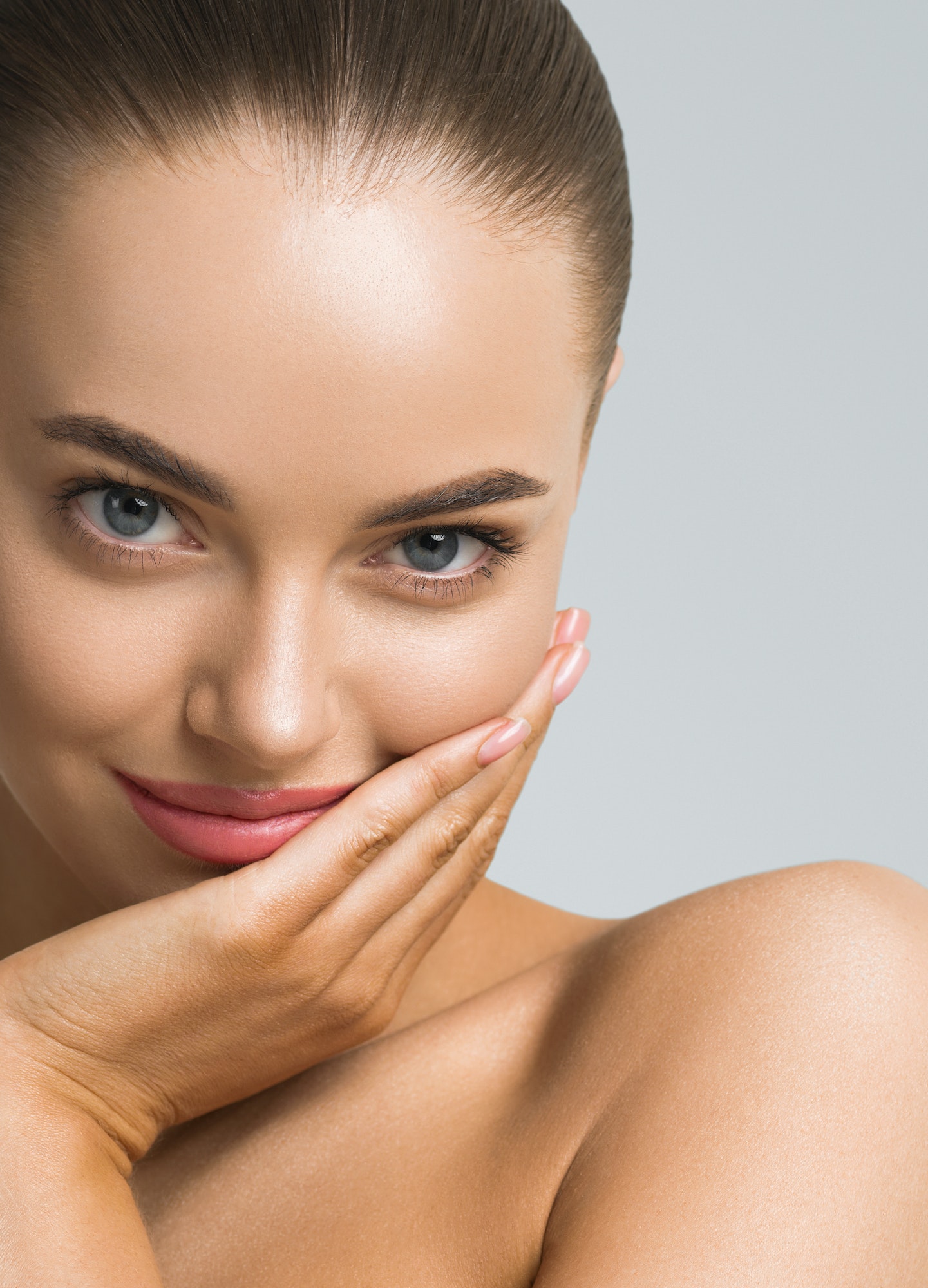 Woman with smooth, clear skin and a radiant smile.