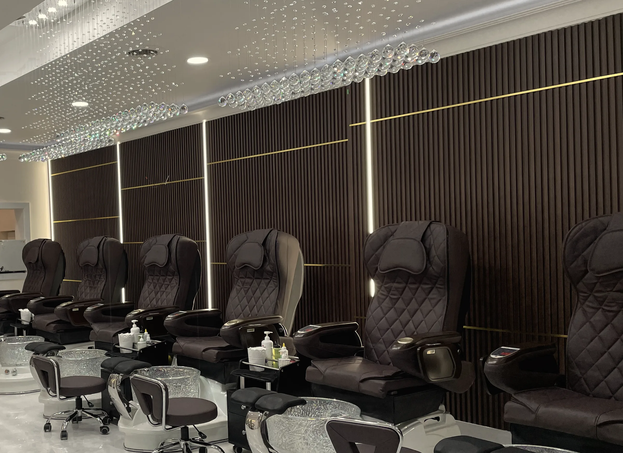 The pedicure lounge at Beautique Bar on Yonge: quilted chairs, wood-slat walls and crystal lighting